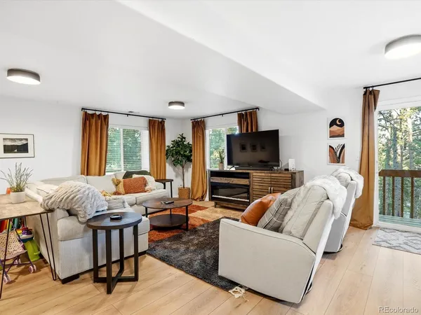 a view of a livingroom with furniture and a window