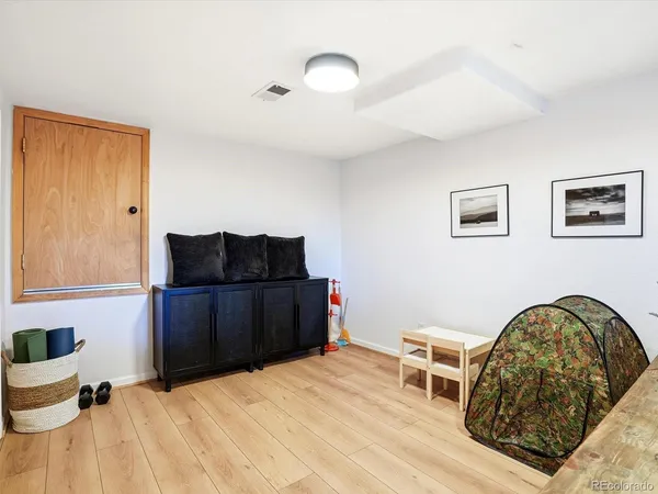 a view of a workspace with furniture and a flat screen tv