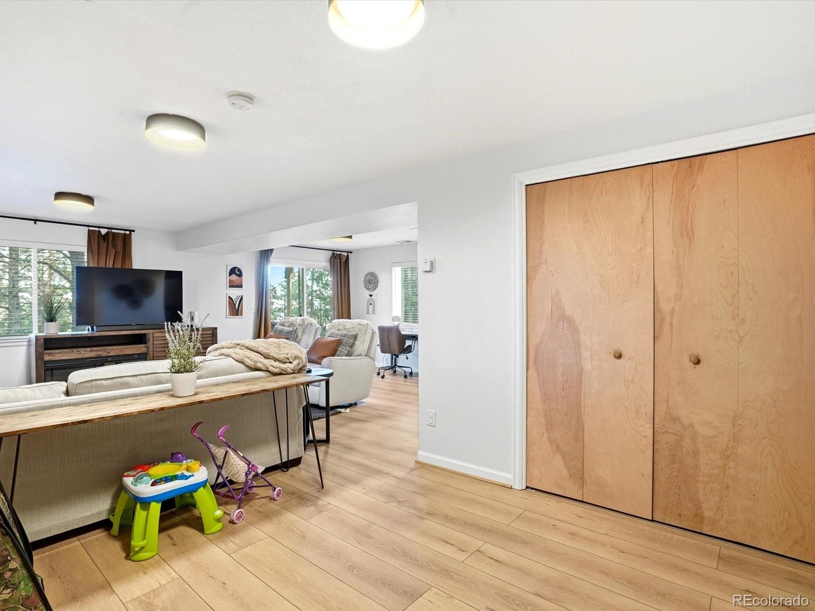 201 Moss Rock Road Bailey, CO 80421 - Photo 33 of 43 a view of a workspace with furniture and a flat screen tv