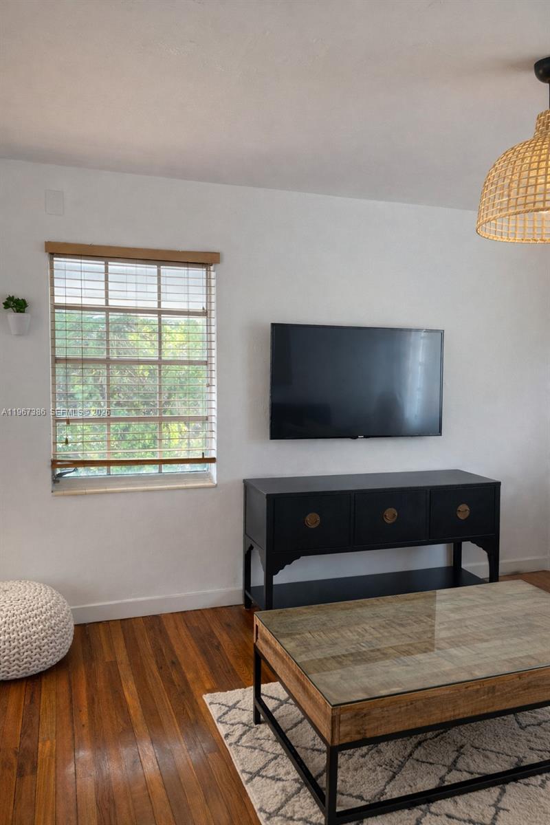 5800 Southwest 61st Street Miami, FL 33143 - Photo 11 of 26 a living room with furniture and a flat screen tv