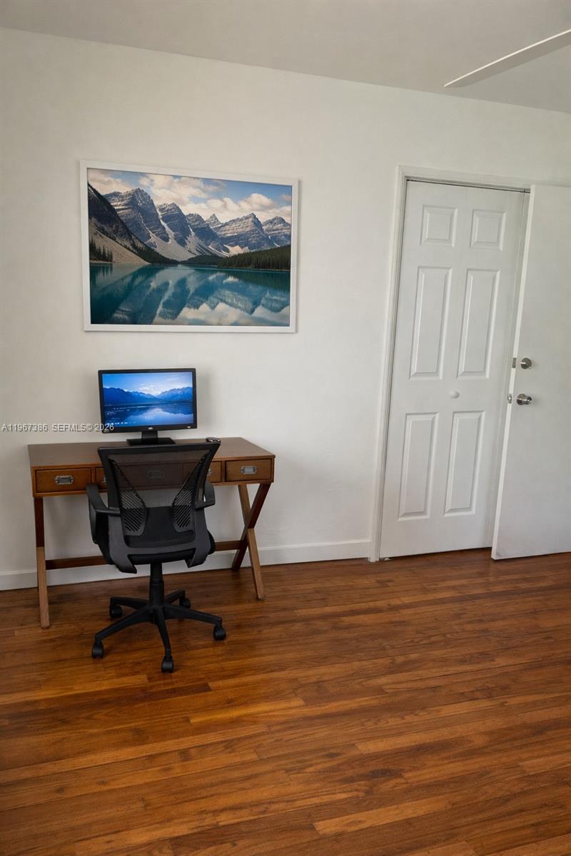 5800 Southwest 61st Street Miami, FL 33143 - Photo 17 of 26 a view of a workspace with furniture and wooden floor