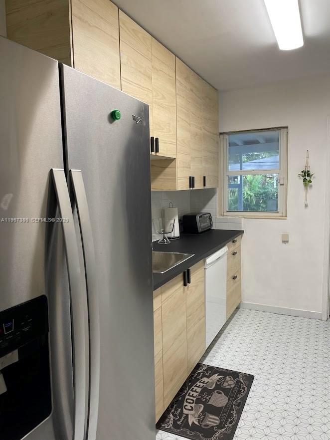 5800 Southwest 61st Street Miami, FL 33143 - Photo 7 of 26 a kitchen with stainless steel appliances granite countertop a refrigerator and a sink