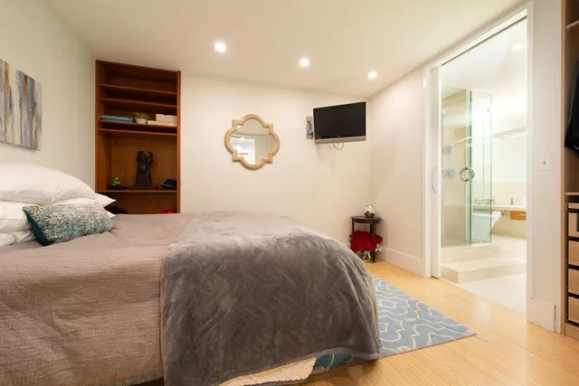 a bedroom with a bed and a flat screen tv
