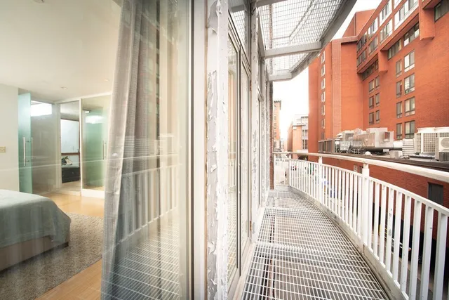 a view of a balcony with wooden floor and door