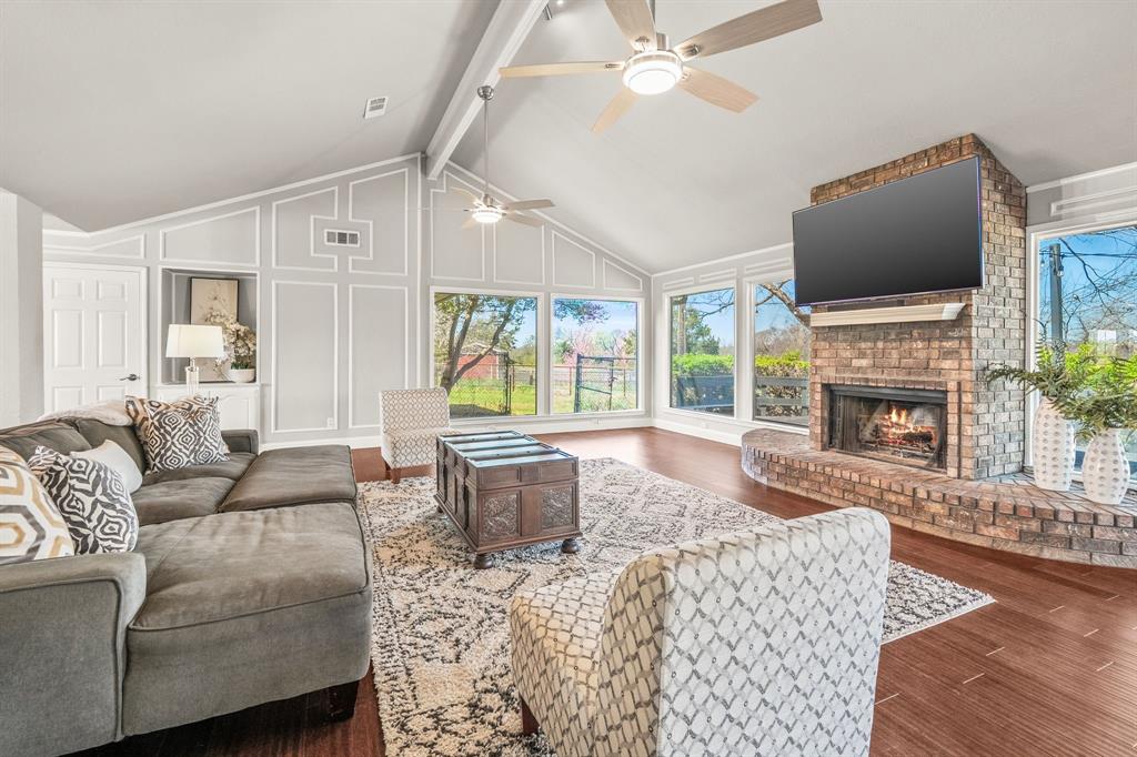 1673 Roadrunner Road Anna, TX 75409 - Photo 22 of 40 Living room with wall of windows and brick fireplace