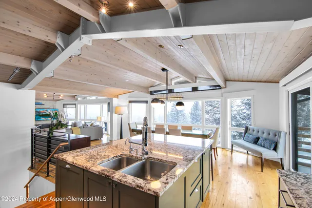 a kitchen with a sink a counter top space and stainless steel appliances