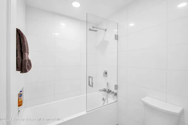 a bathroom with a shower a toilet and a shower