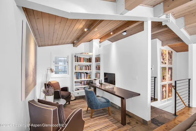 a livingroom with furniture and workspace