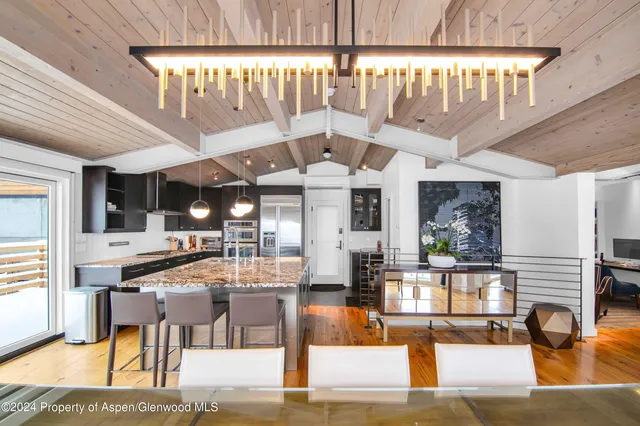 a large room with lots of furniture and chandelier