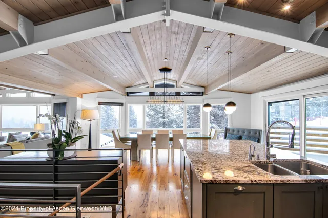 a view of a dining room with furniture wooden floor and chandelier
