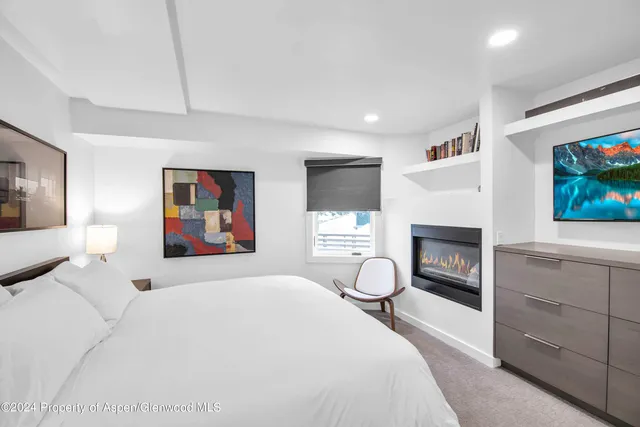 a bedroom with a bed and a fireplace