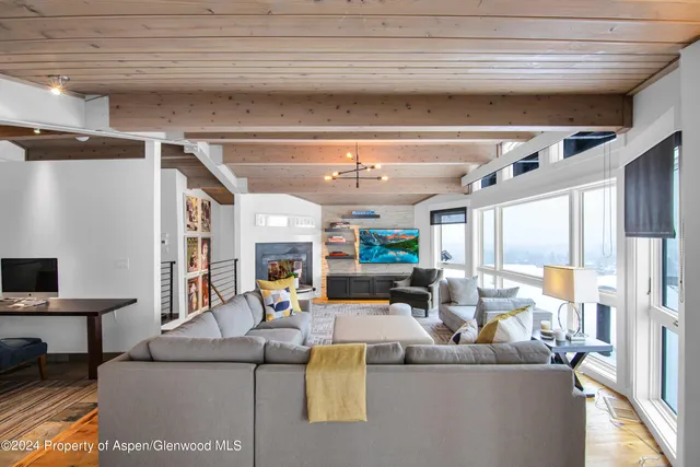 a living room with furniture and a chandelier