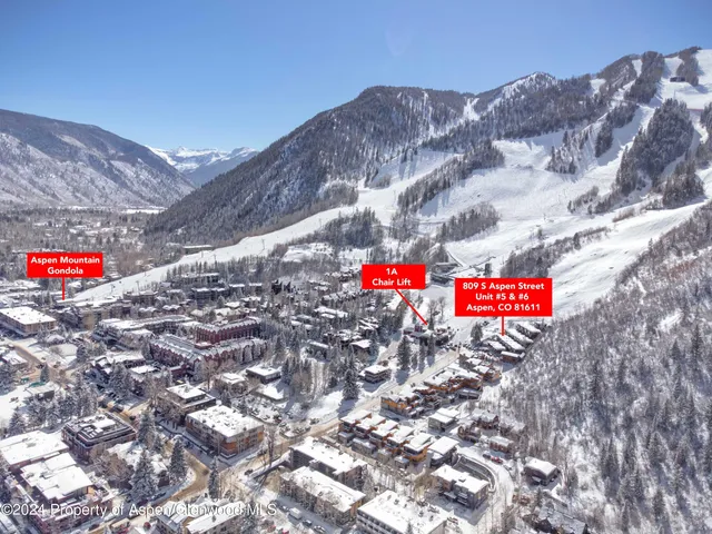 a street sign that is on a brick wall