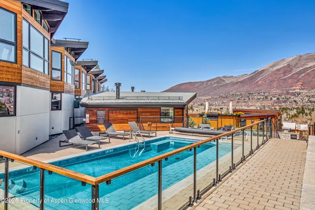 a view of a building with dining table and chairs