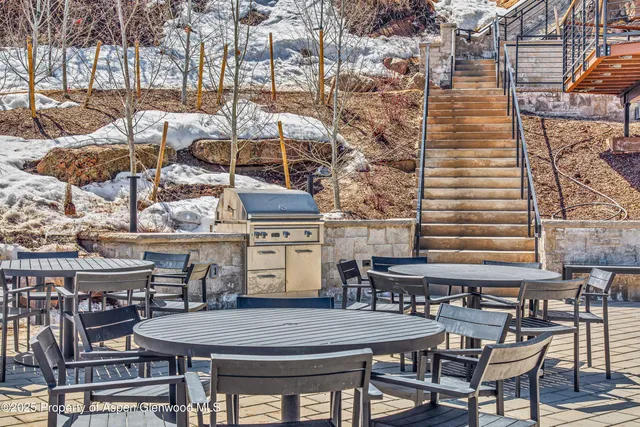 a view of a chairs and table in patio