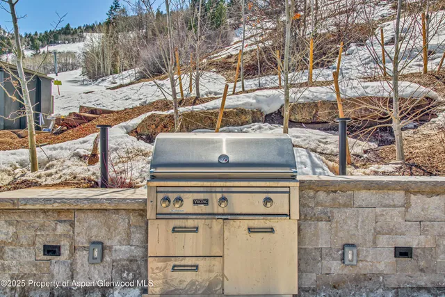 a view of a patio with a table and chairs and potted plants