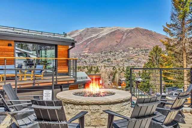 a view of a roof deck with table and chairs