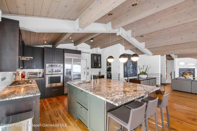 a kitchen with stainless steel appliances granite countertop a stove and refrigerator