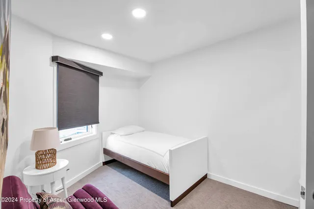 a room with a bed and a window