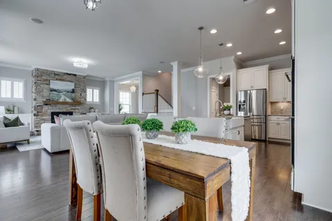 a kitchen with stainless steel appliances kitchen island granite countertop a refrigerator and a stove top oven