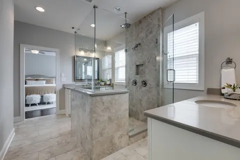 a bathroom with a sink a faucet a mirror and a shower