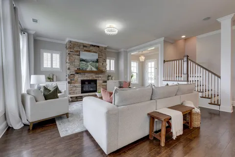 a living room with furniture and a fireplace