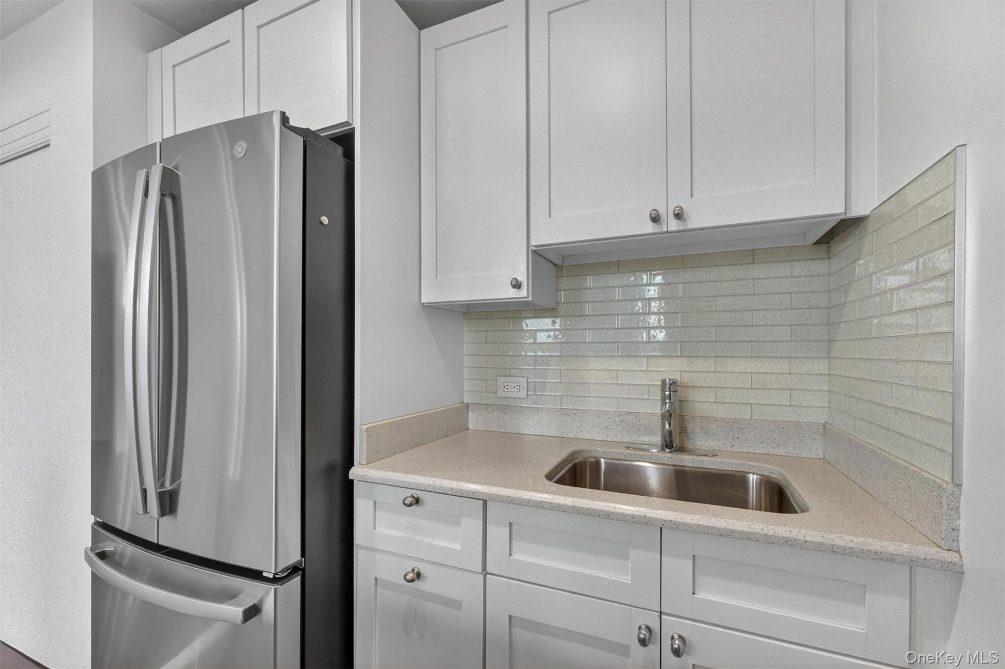5211 Villa At The Peekskill, NY 10566 - Photo 13 of 19 Another view of the fully renovated kitchen highlighting quartz countertops, stainless steel appliances, and a bright, open design.