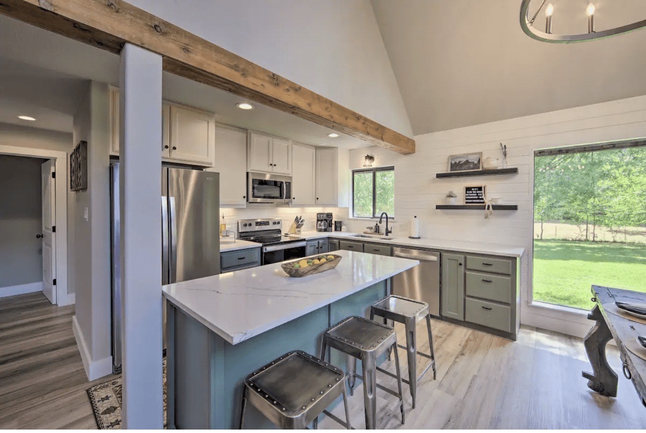 10630 River Ranch Road Kemp, TX 75143 - Photo 6 of 36 a kitchen with a table chairs refrigerator and cabinets