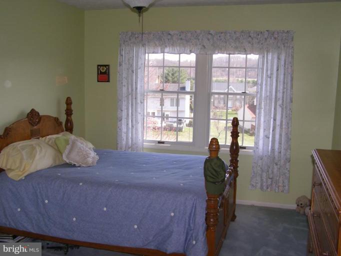 1203 Brookview Road Towson, MD 21286 - Photo 17 of 25 a bedroom with a bed and large windows