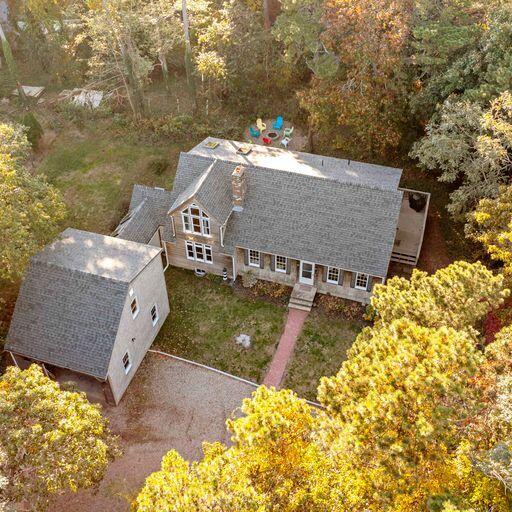 a aerial view of a house with large trees