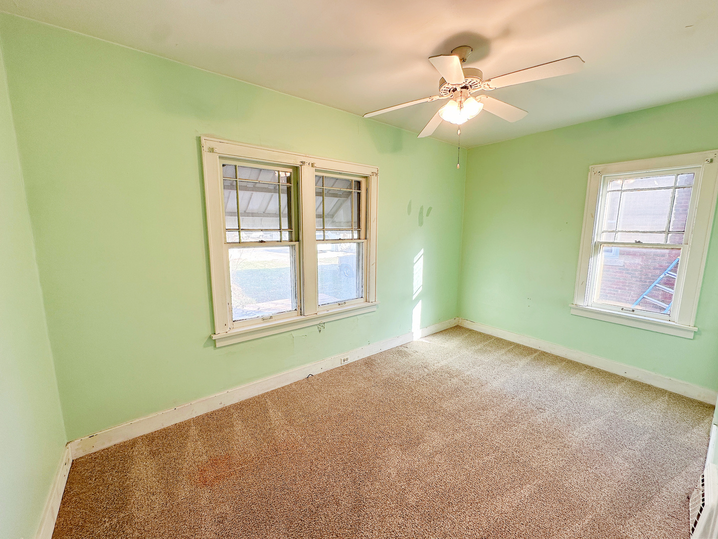 1126 East Main Street Streator, IL 61364 - Photo 14 of 23 an empty room with windows and ceiling fan