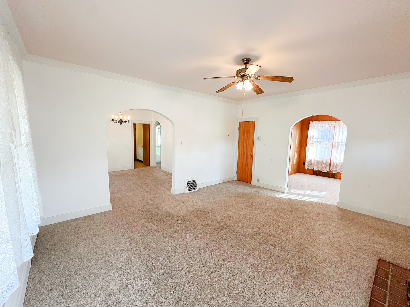 1126 East Main Street Streator, IL 61364 - Photo 5 of 23 a view of a big room with chandelier fan and windows