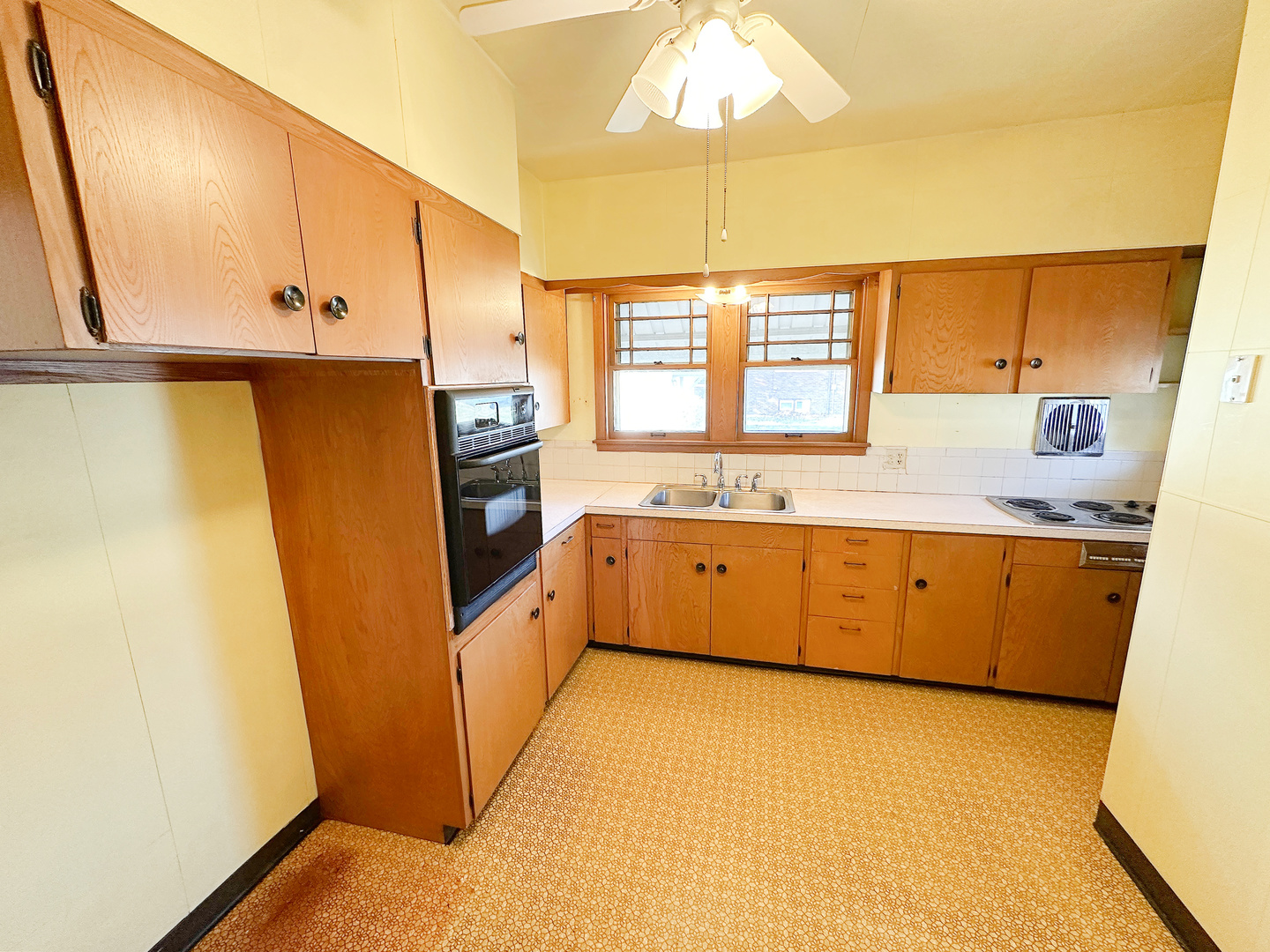 1126 East Main Street Streator, IL 61364 - Photo 10 of 23 a kitchen with a sink a refrigerator and window