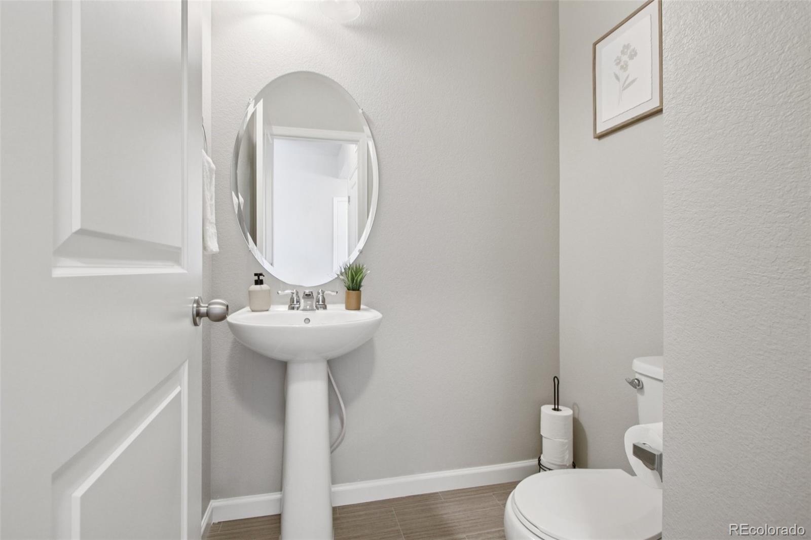1907 Homestead Drive Fort Lupton, CO 80621 - Photo 17 of 47 a bathroom with a toilet sink and mirror