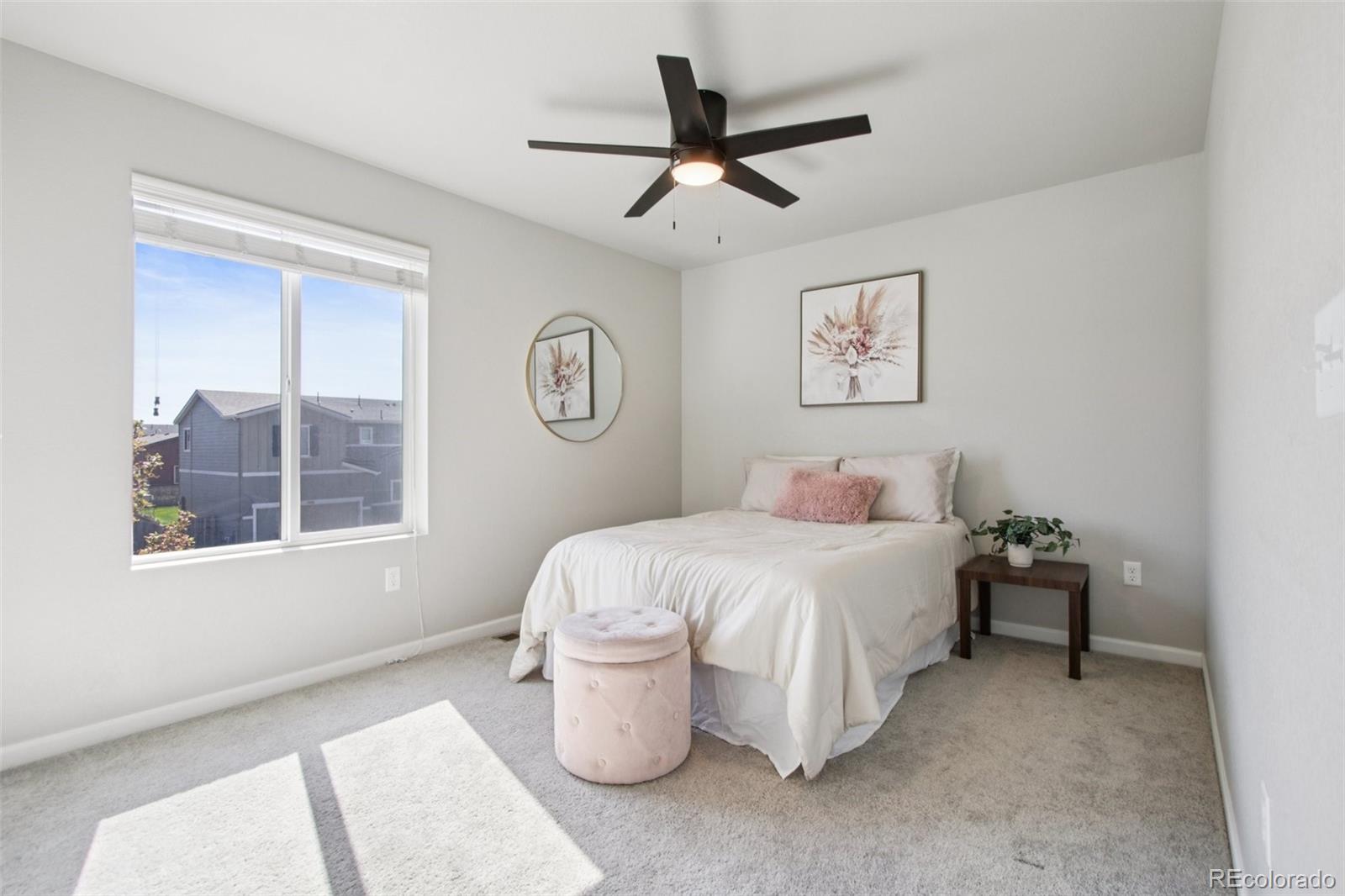 1907 Homestead Drive Fort Lupton, CO 80621 - Photo 24 of 47 a spacious bedroom that has a bed and a window