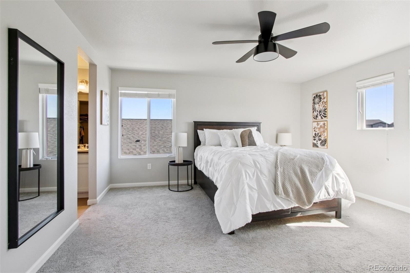 1907 Homestead Drive Fort Lupton, CO 80621 - Photo 27 of 47 a bedroom with a bed and a ceiling fan
