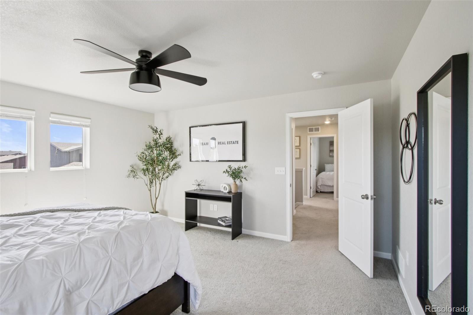 1907 Homestead Drive Fort Lupton, CO 80621 - Photo 28 of 47 a bedroom with a bed and a chandelier