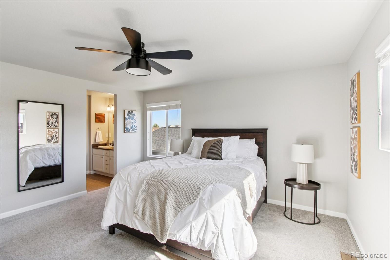 1907 Homestead Drive Fort Lupton, CO 80621 - Photo 29 of 47 a bedroom with a bed chandelier and a window
