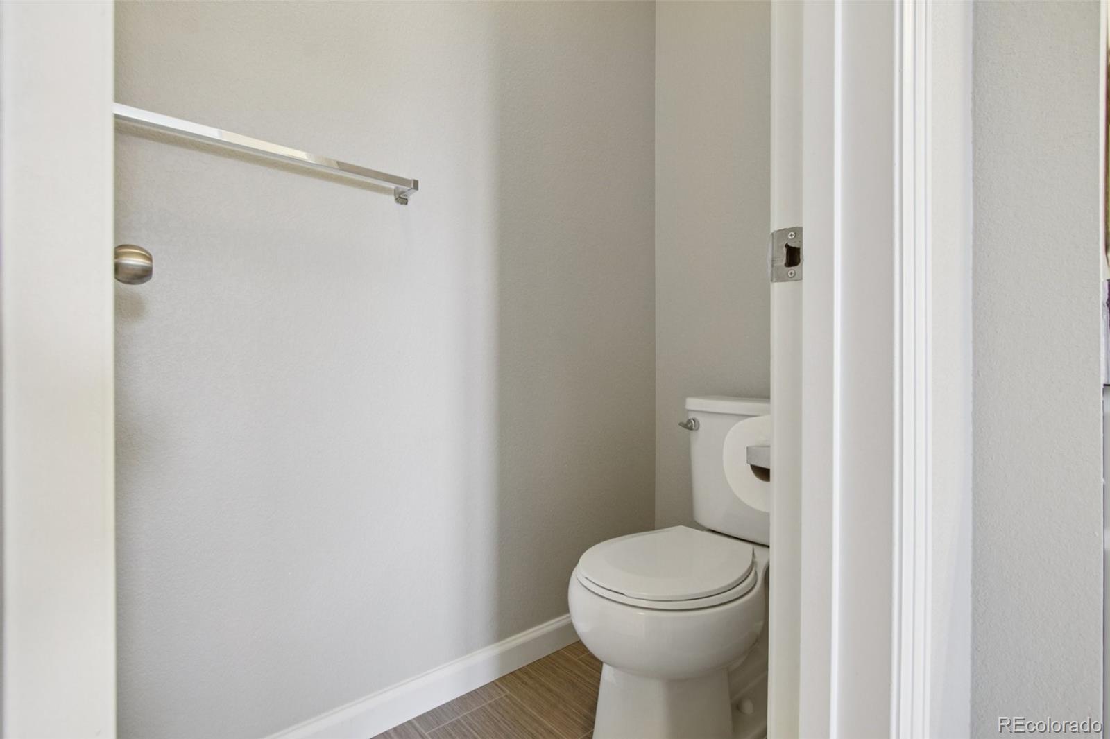 1907 Homestead Drive Fort Lupton, CO 80621 - Photo 33 of 47 a white toilet sitting next to a bathroom sink