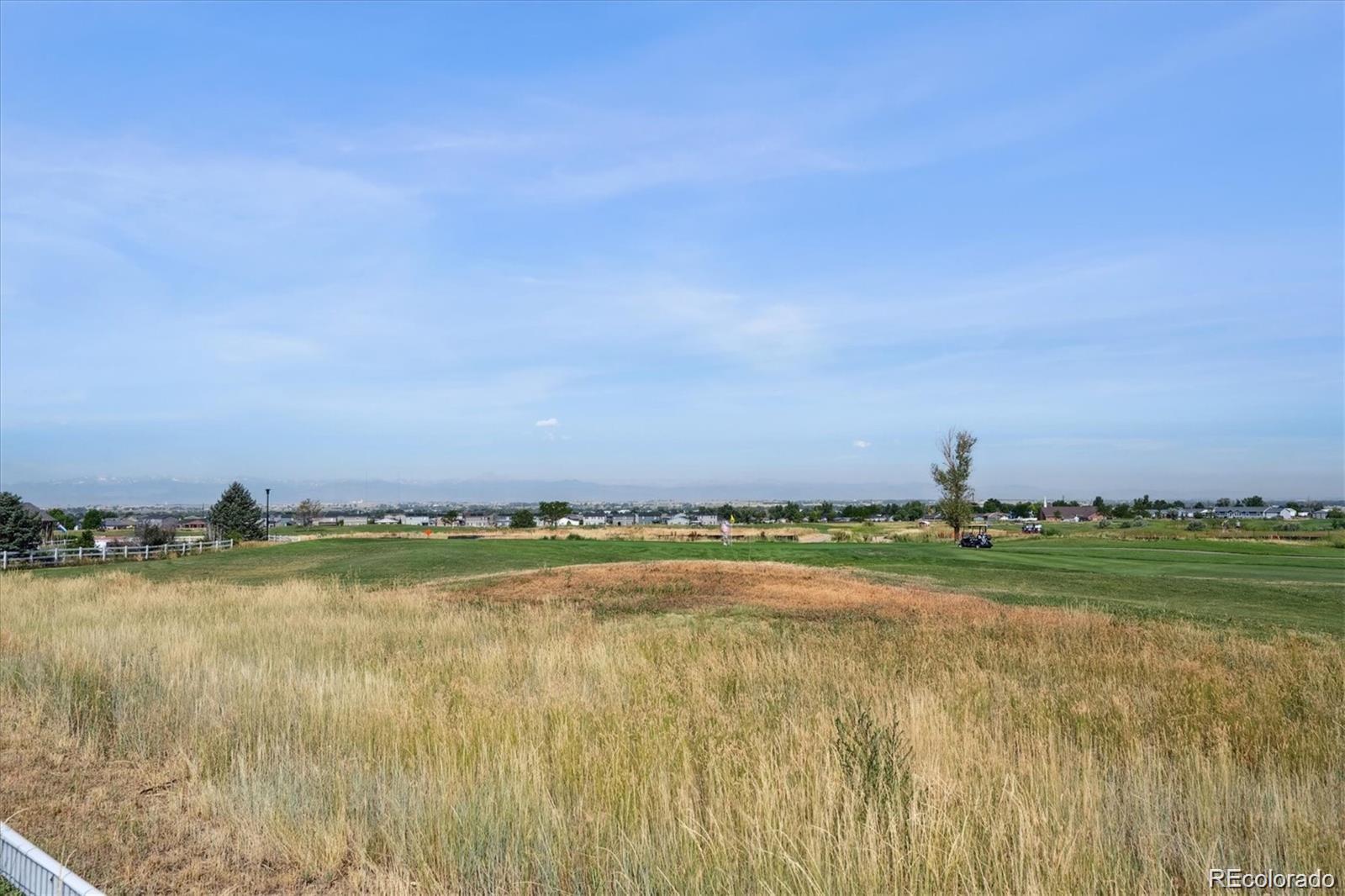 1907 Homestead Drive Fort Lupton, CO 80621 - Photo 46 of 47 a view of a lake and a yard