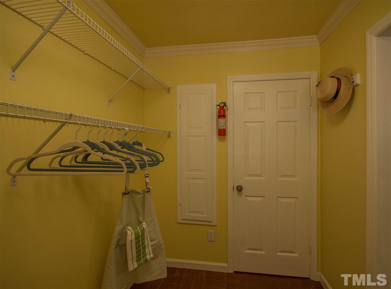 7626 Herndon Road Durham, NC 27713 - Photo 14 of 25 The brick flooring continues into this large space. Note the convenient built-in ironing board!