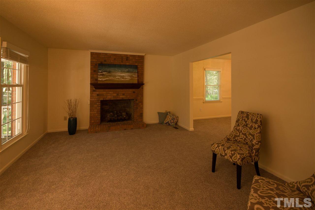7626 Herndon Road Durham, NC 27713 - Photo 5 of 25 Features brick fireplace with gas logs. Windows overlook front porch.