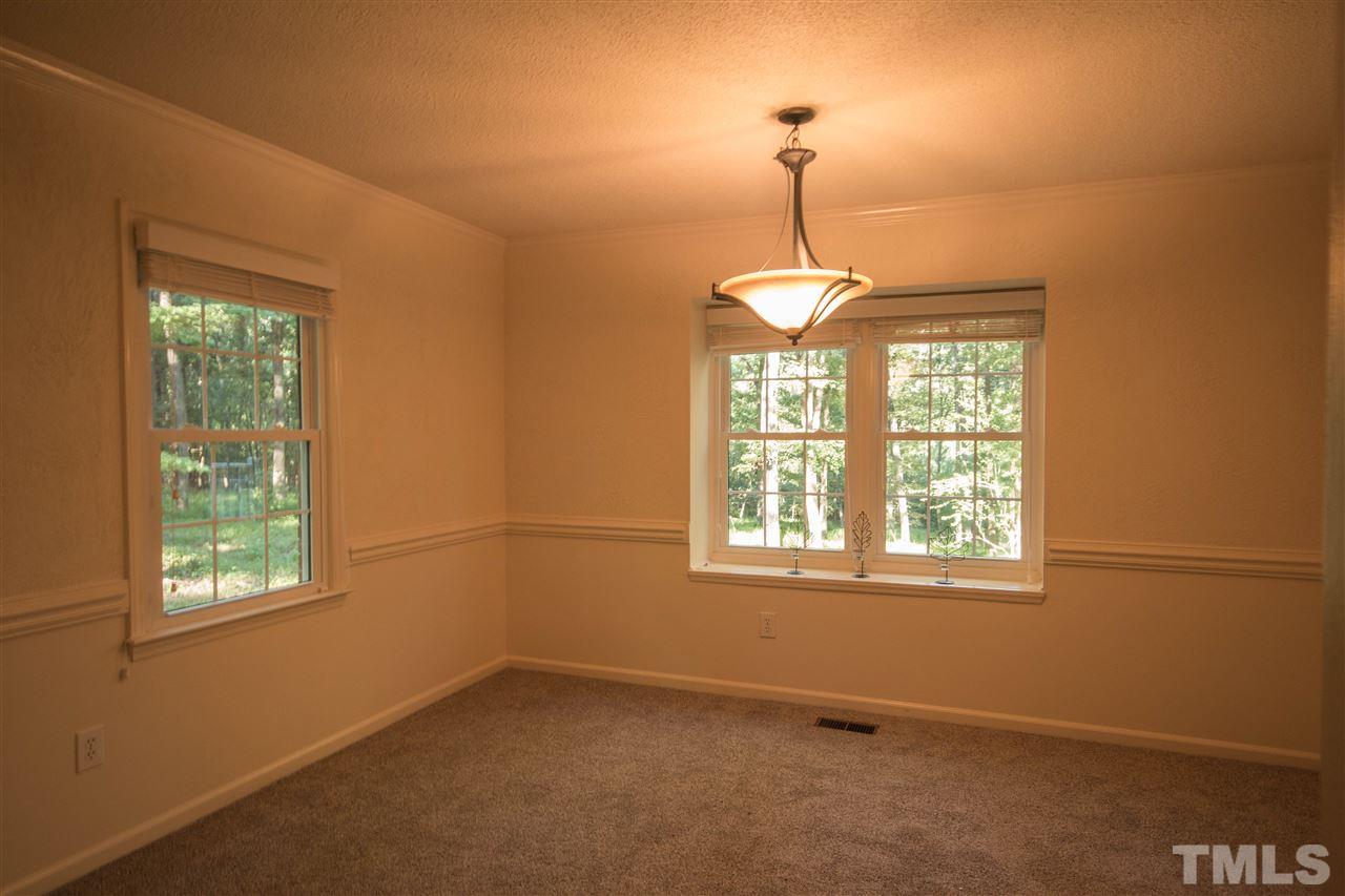 7626 Herndon Road Durham, NC 27713 - Photo 7 of 25 Has updated chandelier, chair rail, and windows overlook the side and back of the acreage.