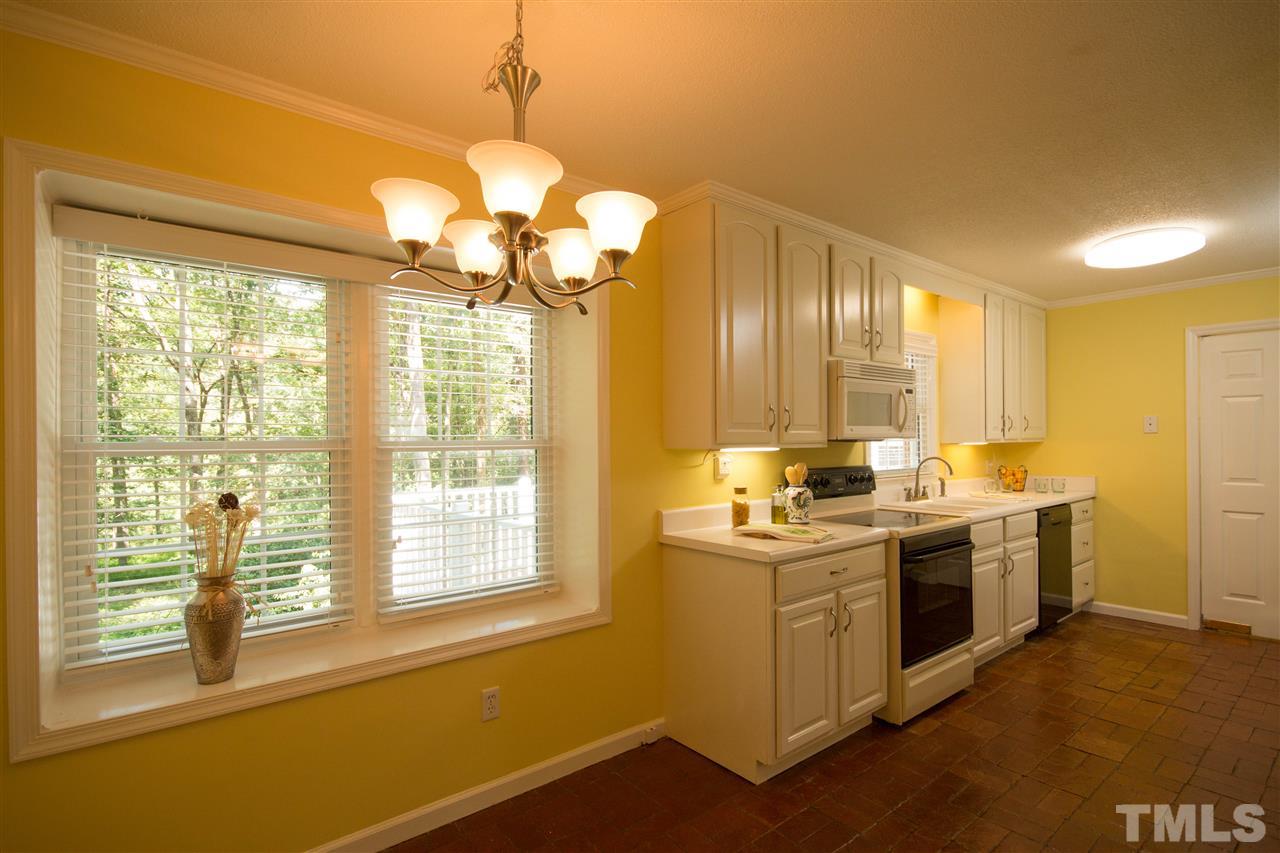 7626 Herndon Road Durham, NC 27713 - Photo 10 of 25 The sunny Kitchen and Breakfast Area have beautiful brick flooring. There is new double ceramic sink with an updated faucet. The cabinetry is beautifully crafted.