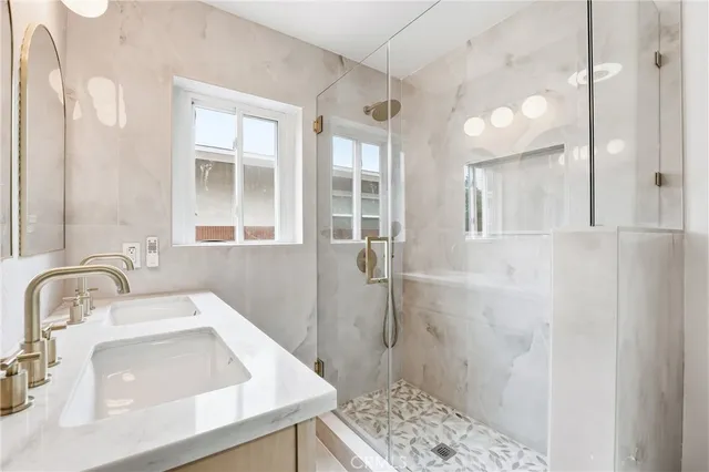 a bathroom with a sink a toilet and shower