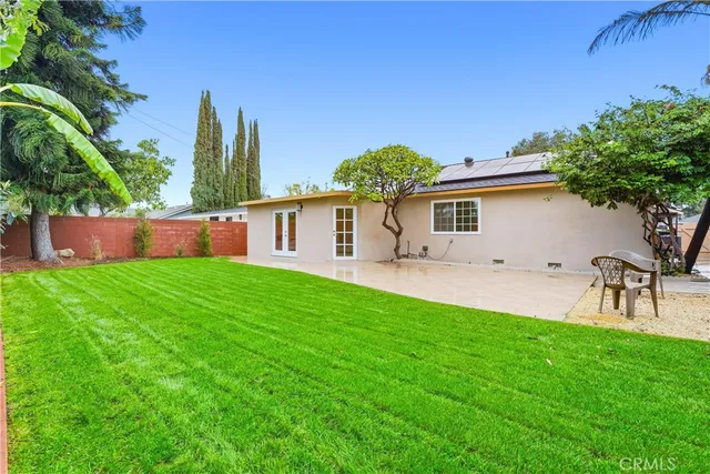 a front view of house with yard and outdoor seating