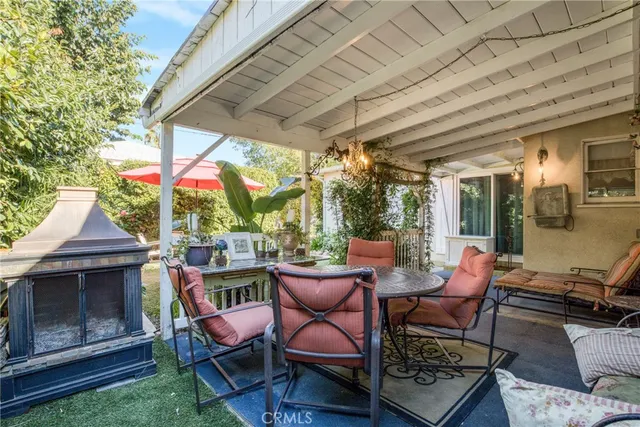 a view of a chairs and table in backyard of the house