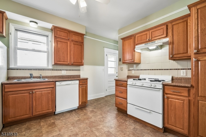 68 North Street, Unit 2 Madison, NJ 07940 - Photo 5 of 18 a kitchen with granite countertop a sink stainless steel appliances and cabinets