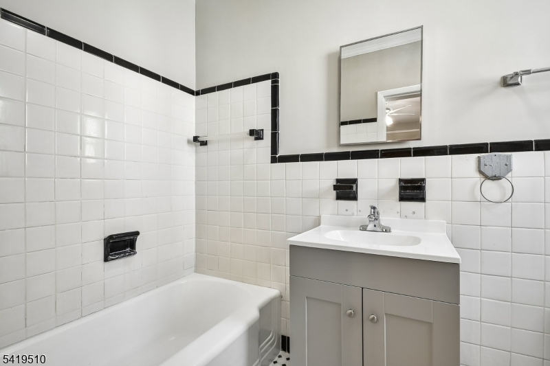 68 North Street, Unit 2 Madison, NJ 07940 - Photo 8 of 18 a bathroom with a sink and a mirror