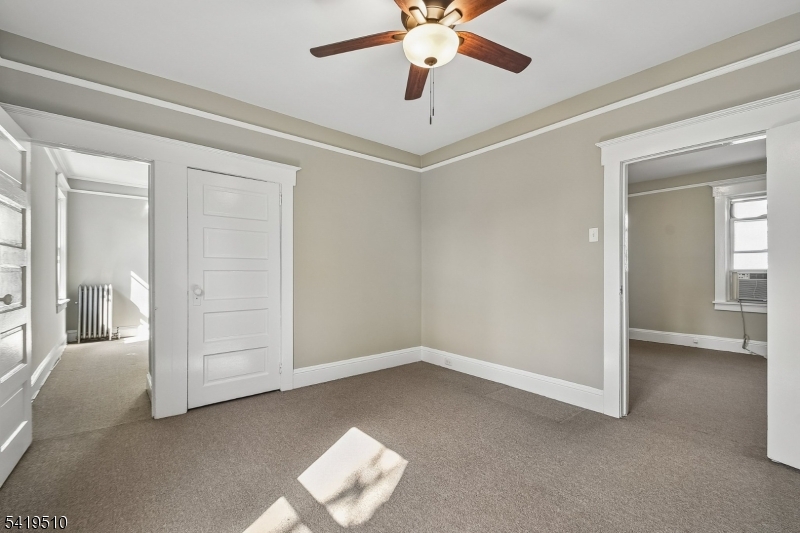 68 North Street, Unit 2 Madison, NJ 07940 - Photo 9 of 18 an empty room with windows and fan